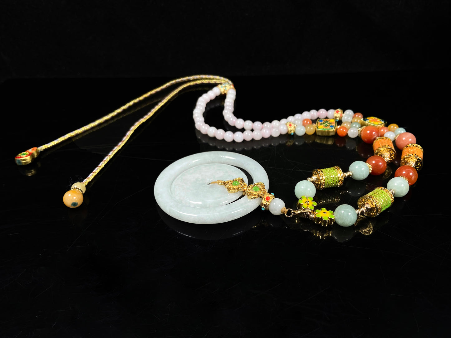 A sleek pale white double ring peace buckle jadeite pendant.