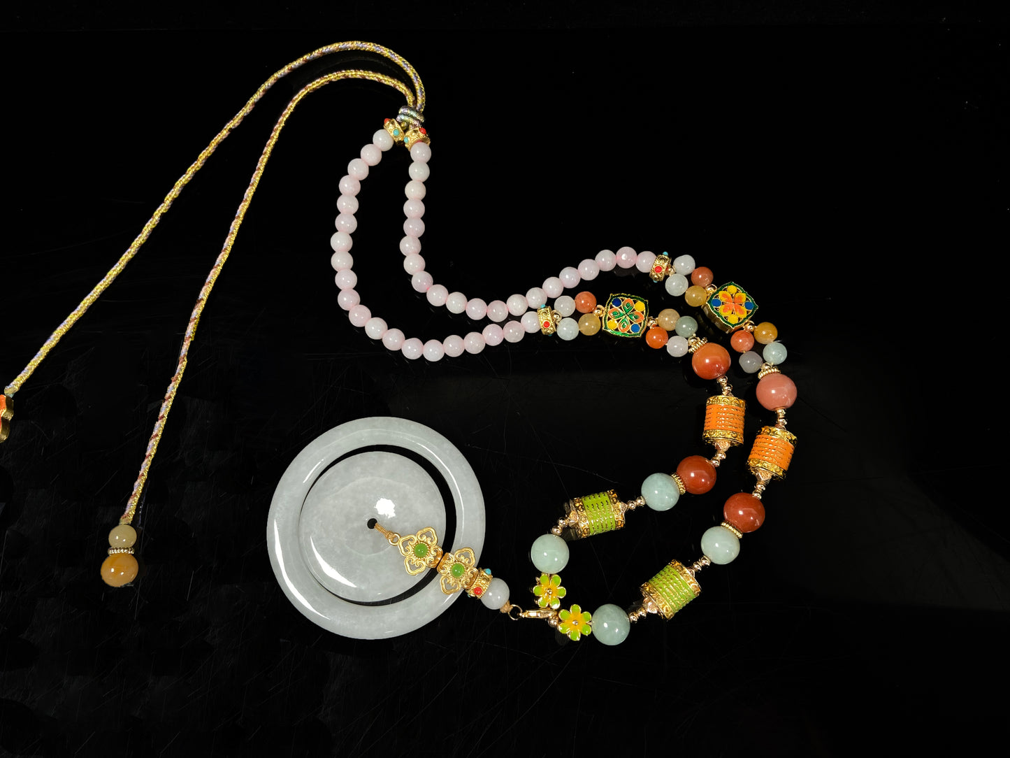 A sleek pale white double ring peace buckle jadeite pendant.