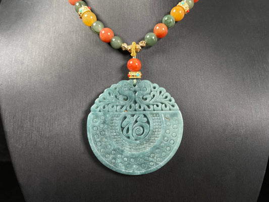 A misty teal fortune motif jadeite pendant.