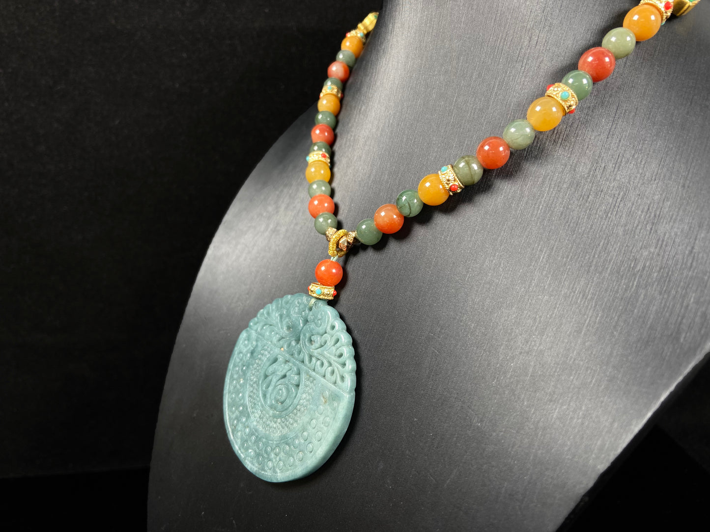 A misty teal fortune motif jadeite pendant.