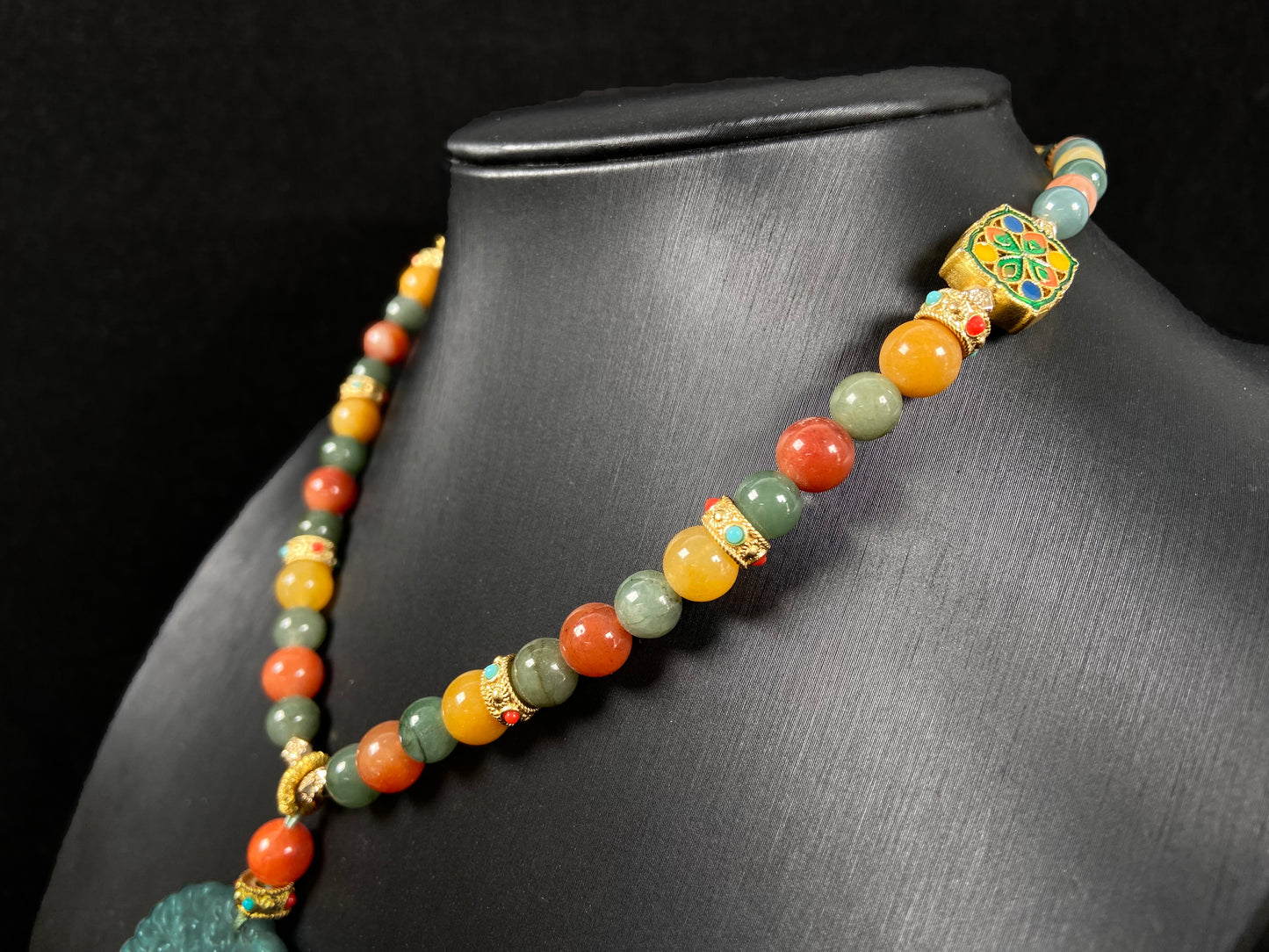 A misty teal fortune motif jadeite pendant.