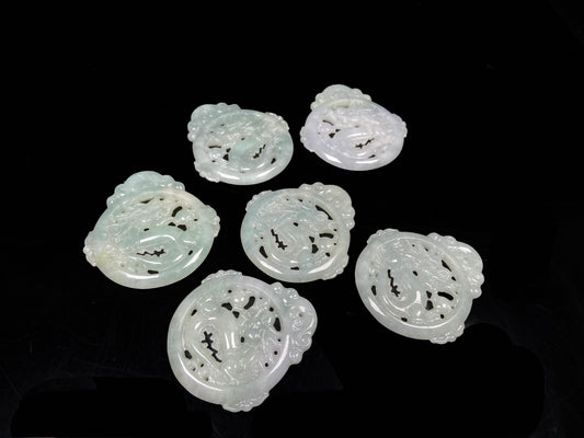 A pale green hollow dragon jadeite pendant.