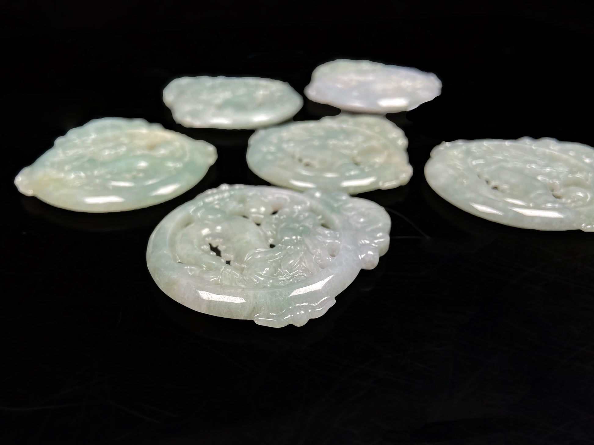 A pale green hollow dragon jadeite pendant.