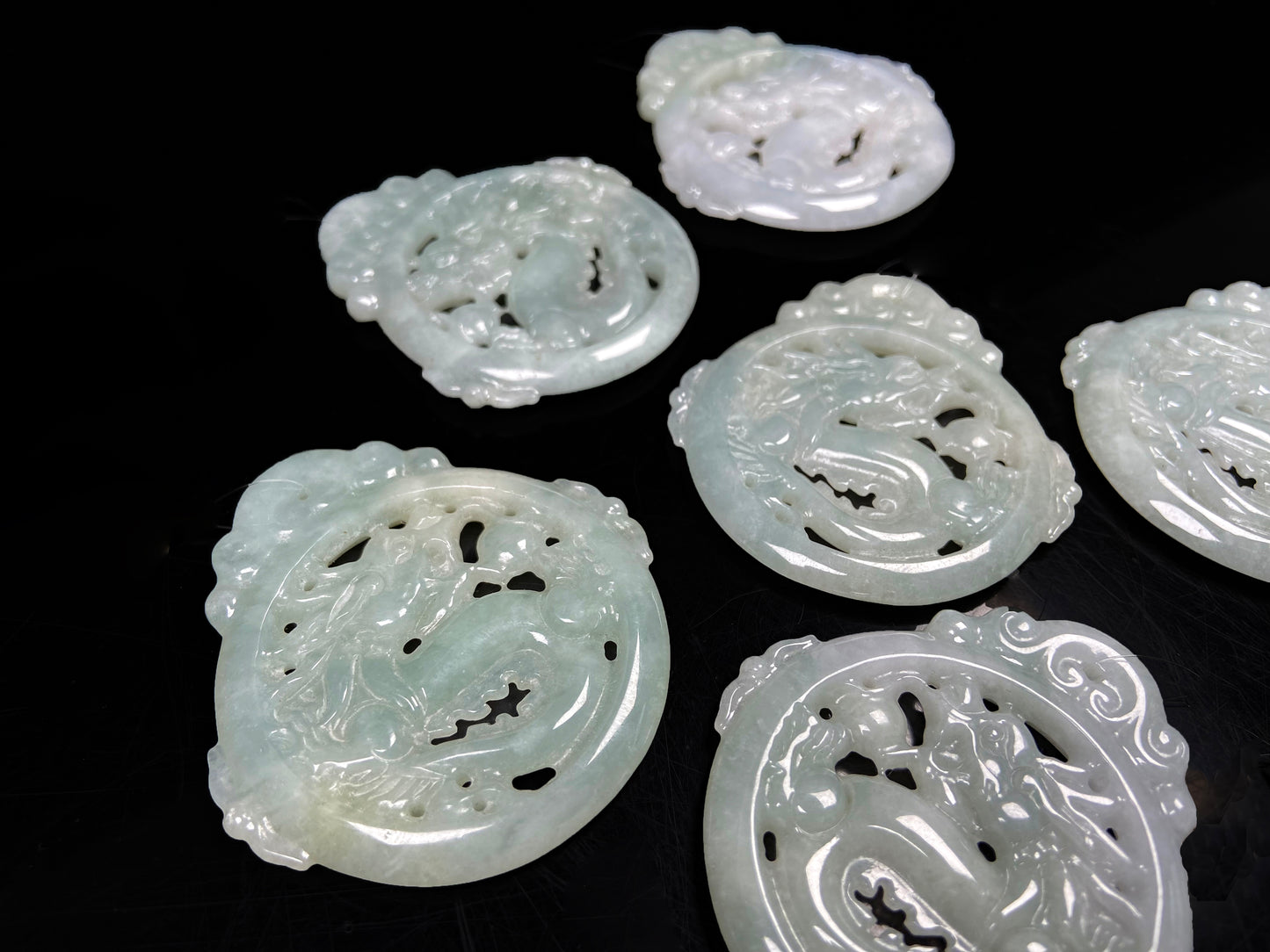 A pale green hollow dragon jadeite pendant.