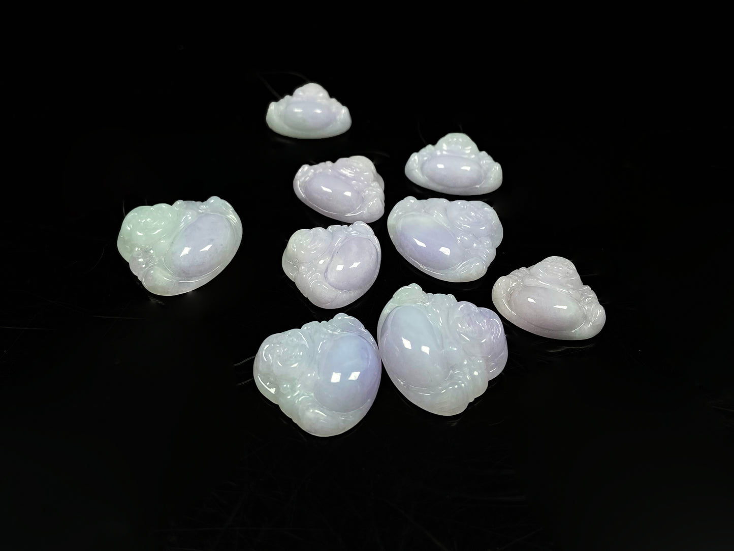 A lavender green buddha loose jadeite group.