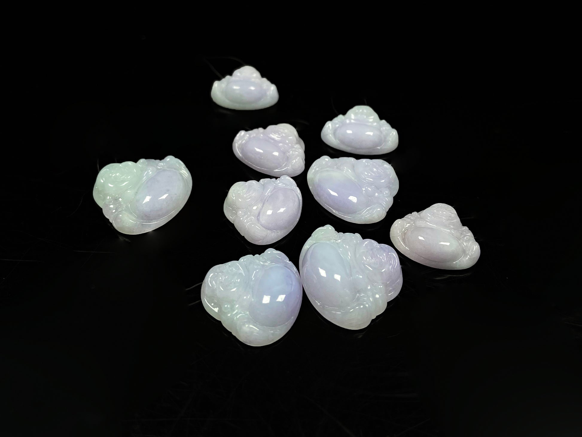 A lavender green buddha loose jadeite group.
