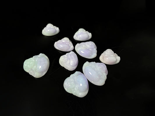 A lavender green buddha loose jadeite group.