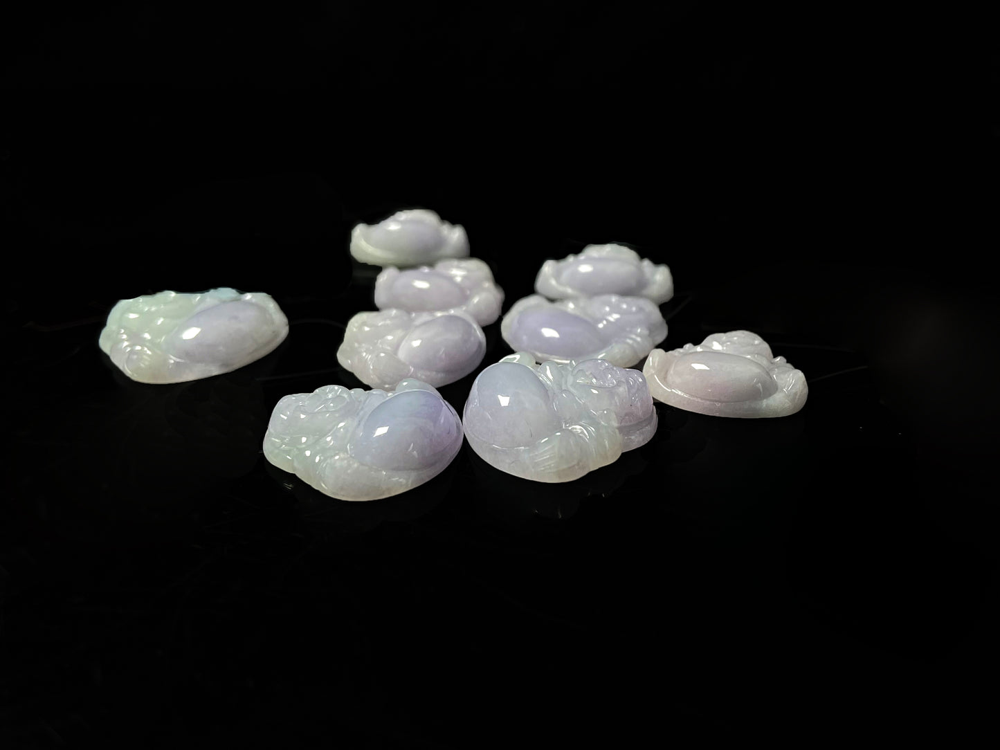 A lavender green buddha loose jadeite group.