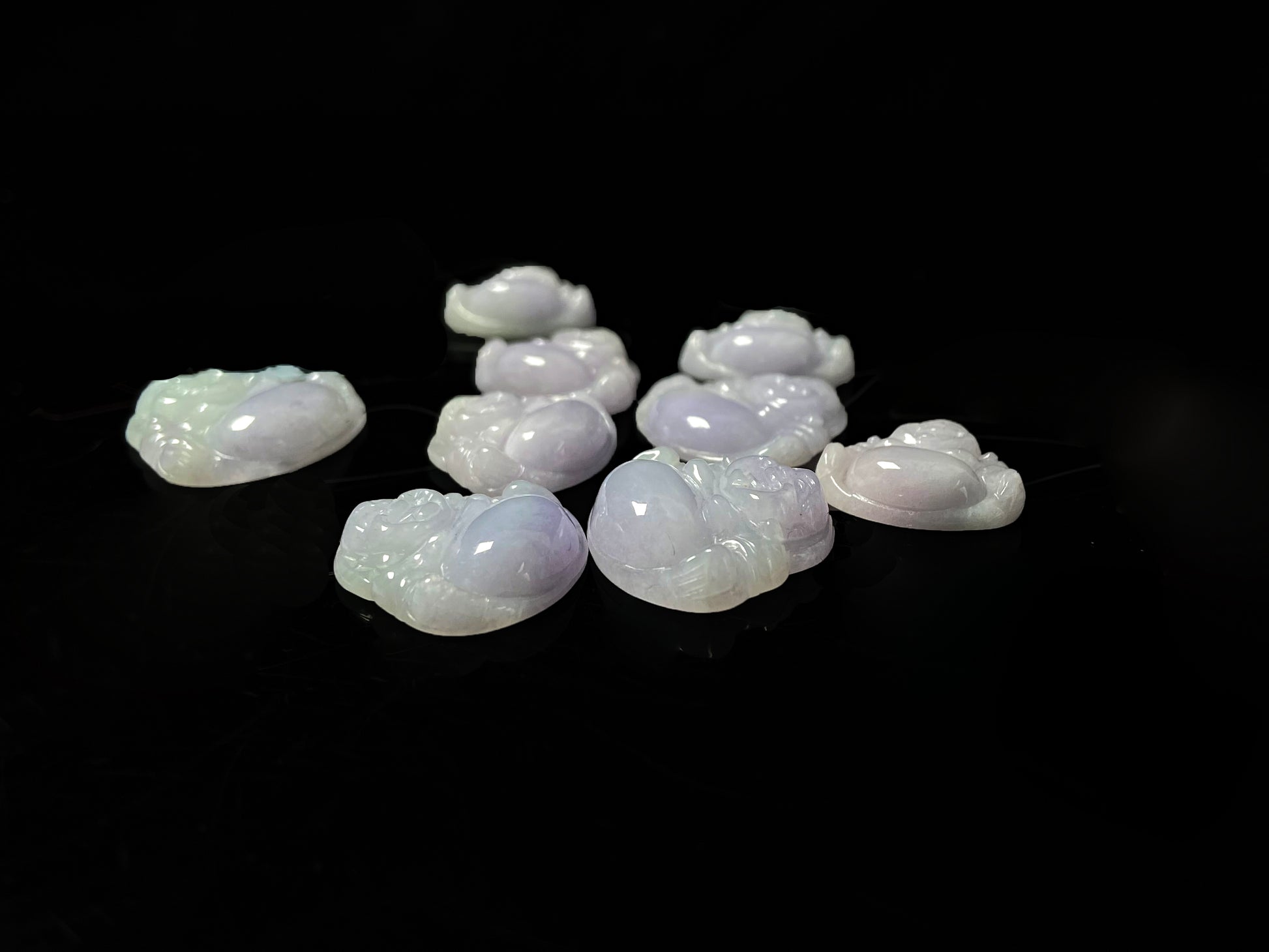A lavender green buddha loose jadeite group.