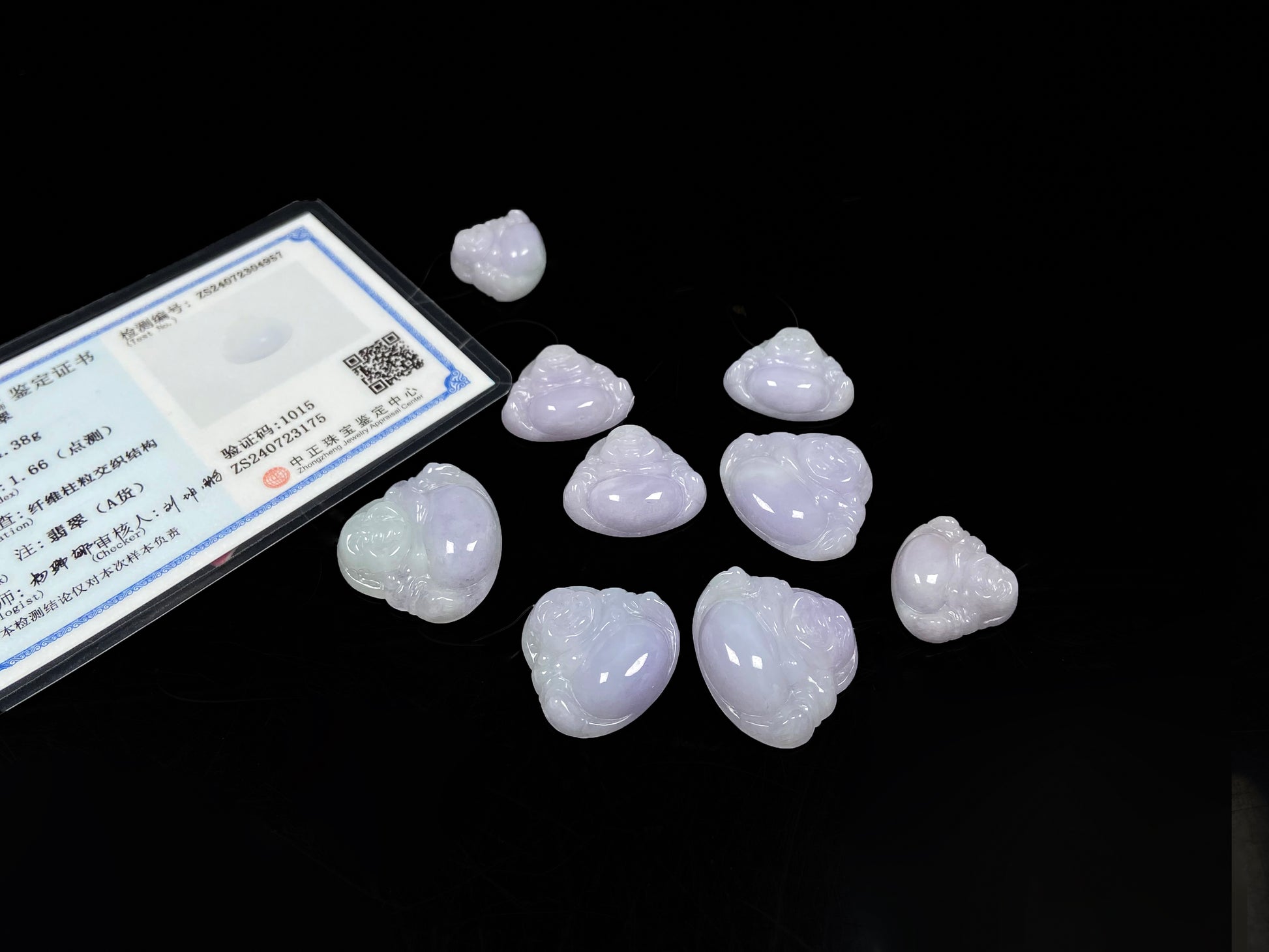 A lavender green buddha loose jadeite group.