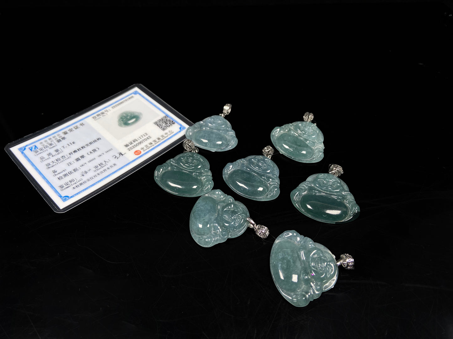 A glacial blue green Buddha jadeite pendant group.