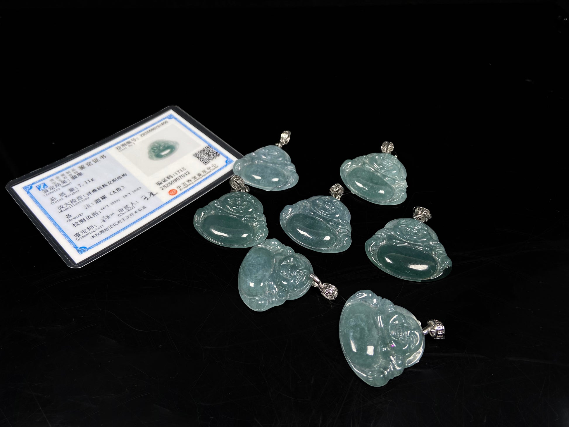 A glacial blue green Buddha jadeite pendant group.