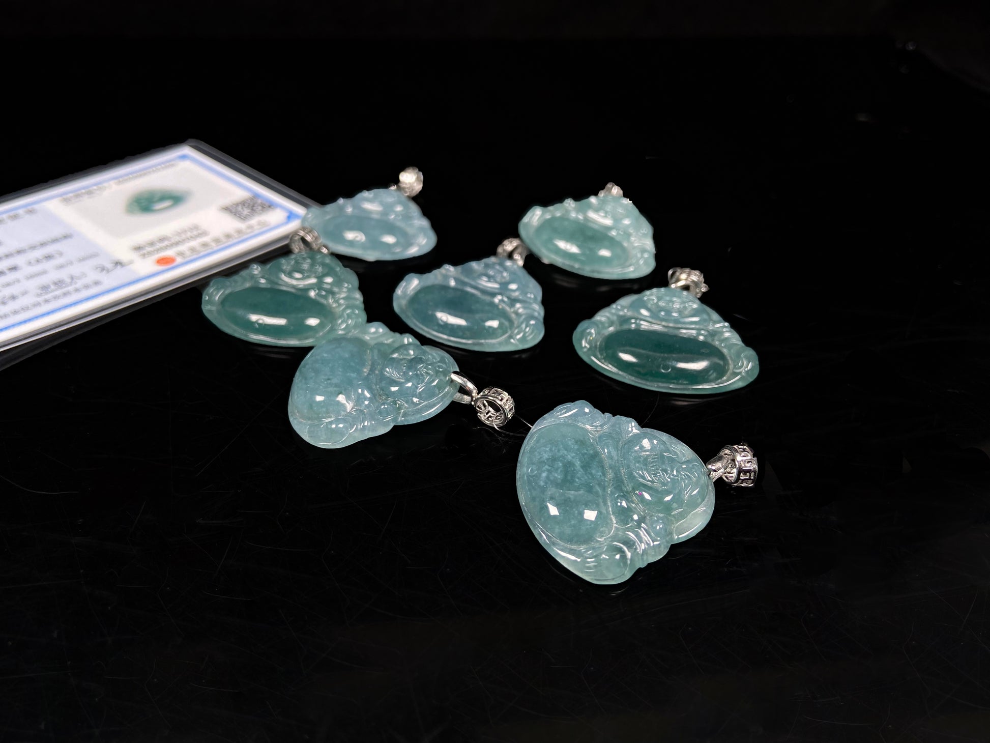 A glacial blue green Buddha jadeite pendant group.