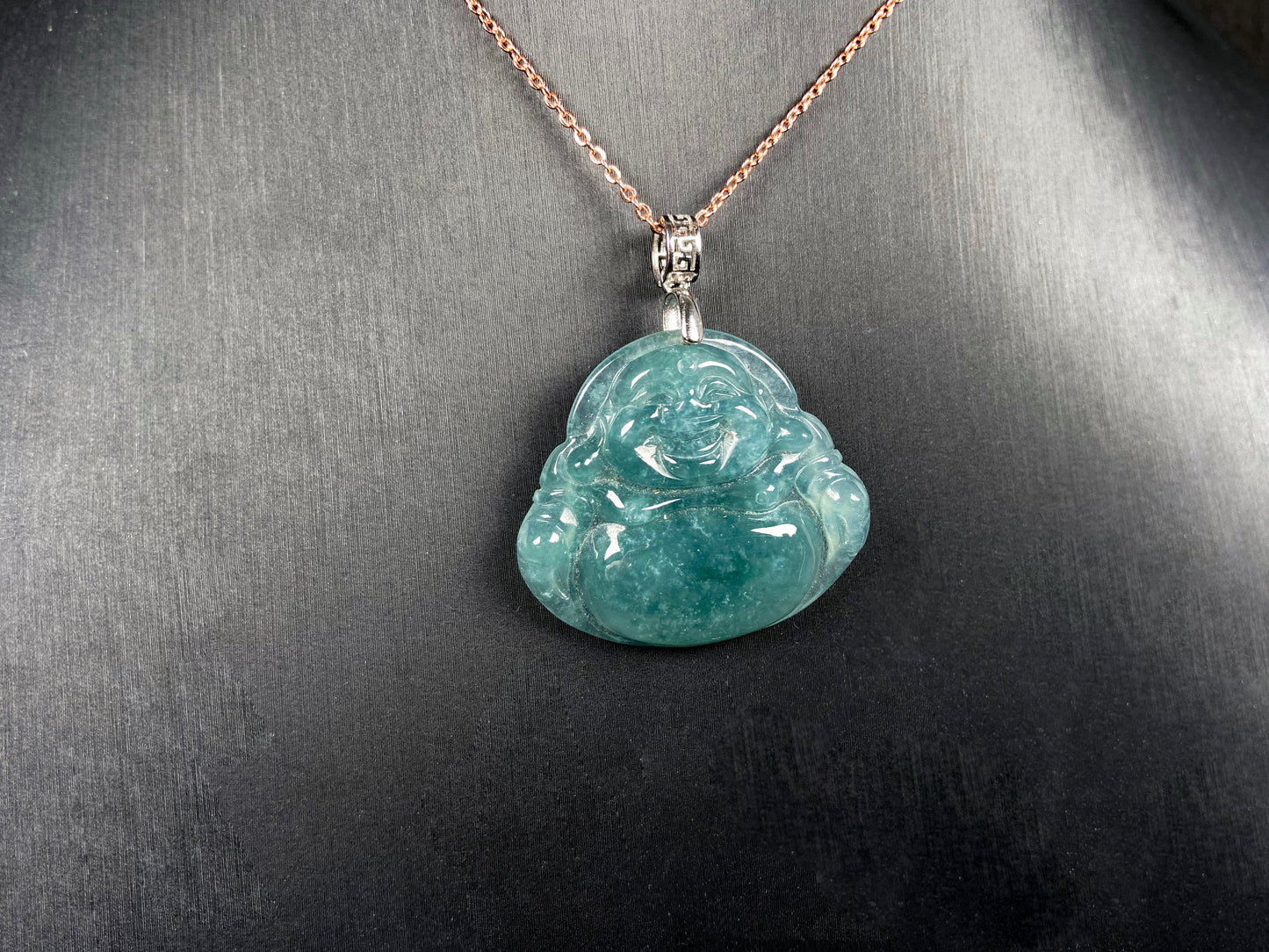 A glacial blue green Buddha jadeite pendant group.