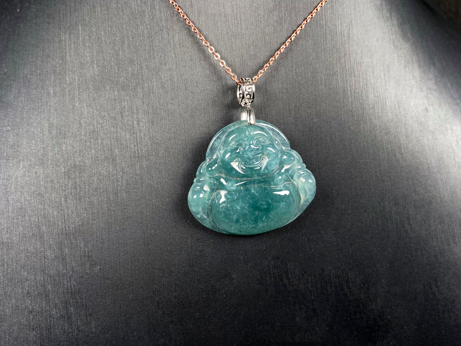 A glacial blue green Buddha jadeite pendant group.