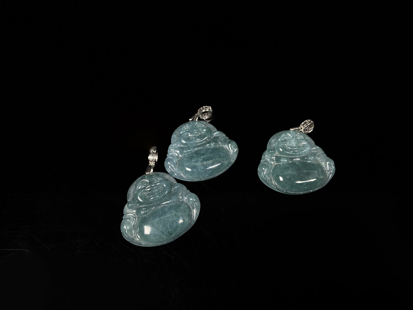 A glacial blue green Buddha jadeite pendant group.
