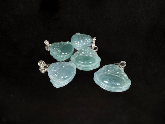 A glacial blue green buddha jadeite pendant group.
