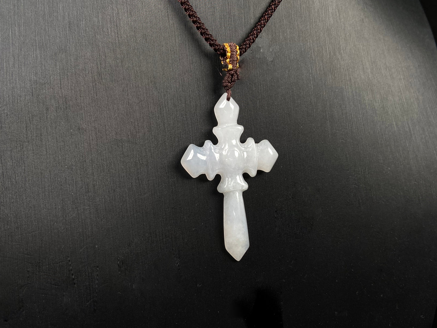 A milky white sword cross jadeite pendant.