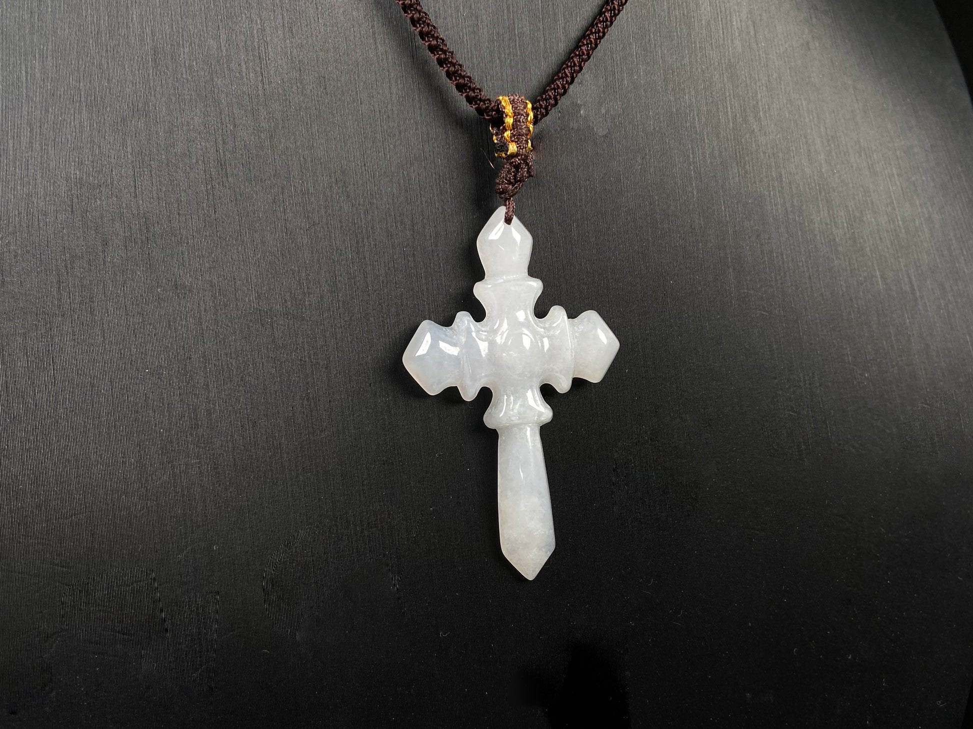 A milky white sword cross jadeite pendant.