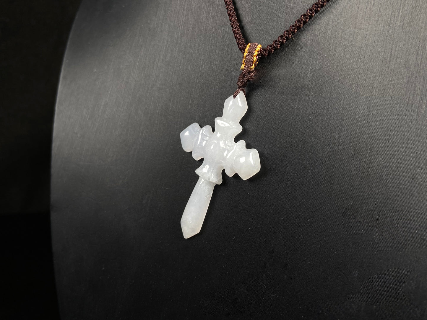 A milky white sword cross jadeite pendant.