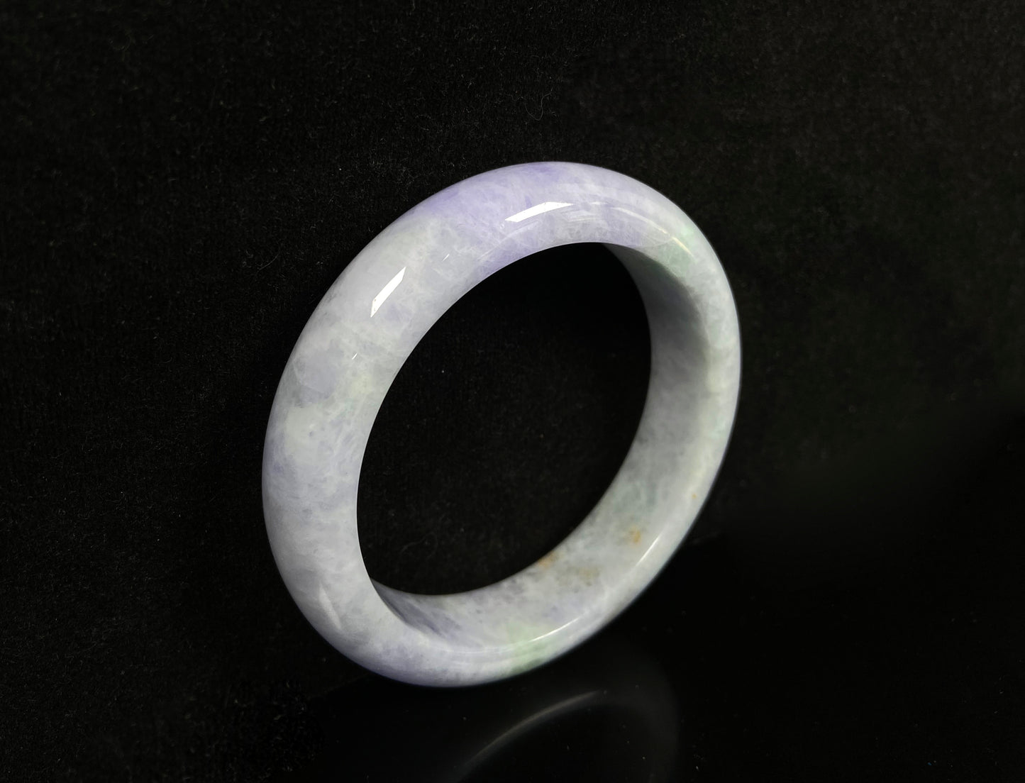 A pale lavender purple base with gentle green accents jadeite bangle.