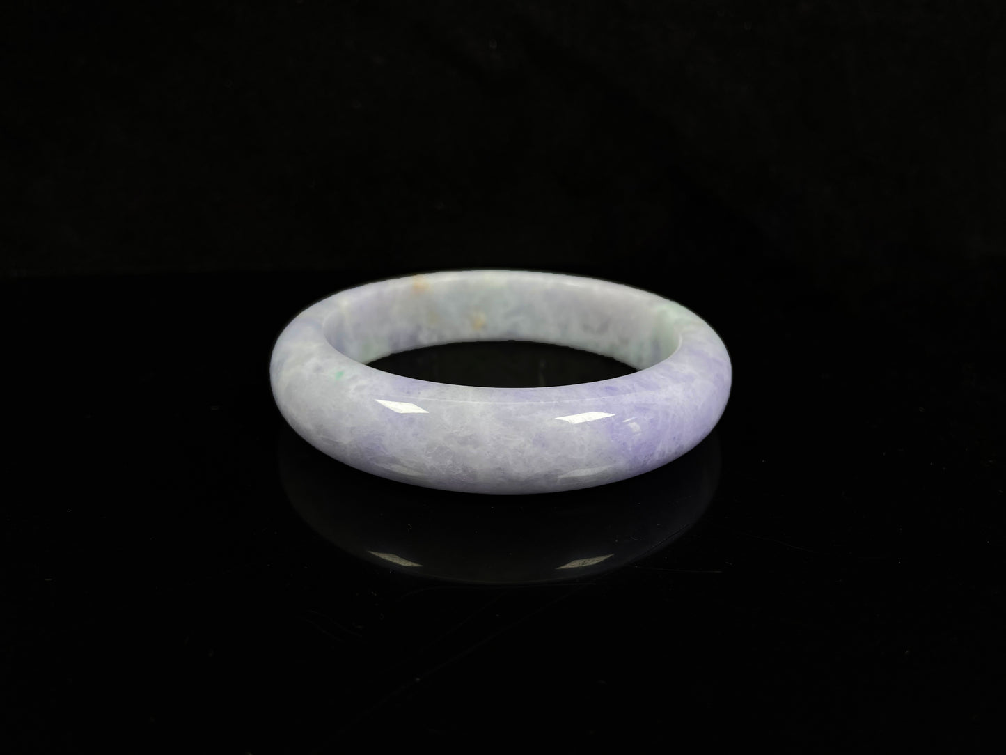 A pale lavender purple base with gentle green accents jadeite bangle.