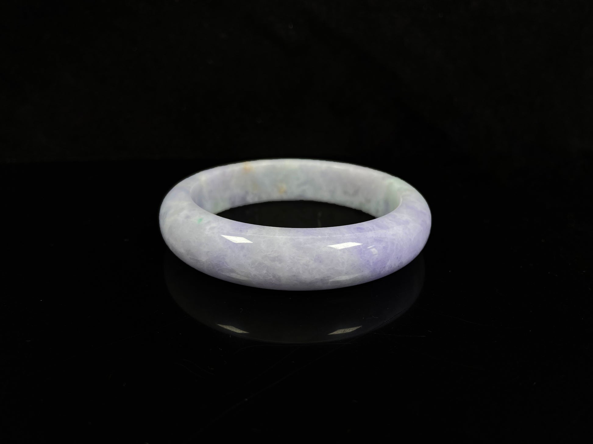 A pale lavender purple base with gentle green accents jadeite bangle.