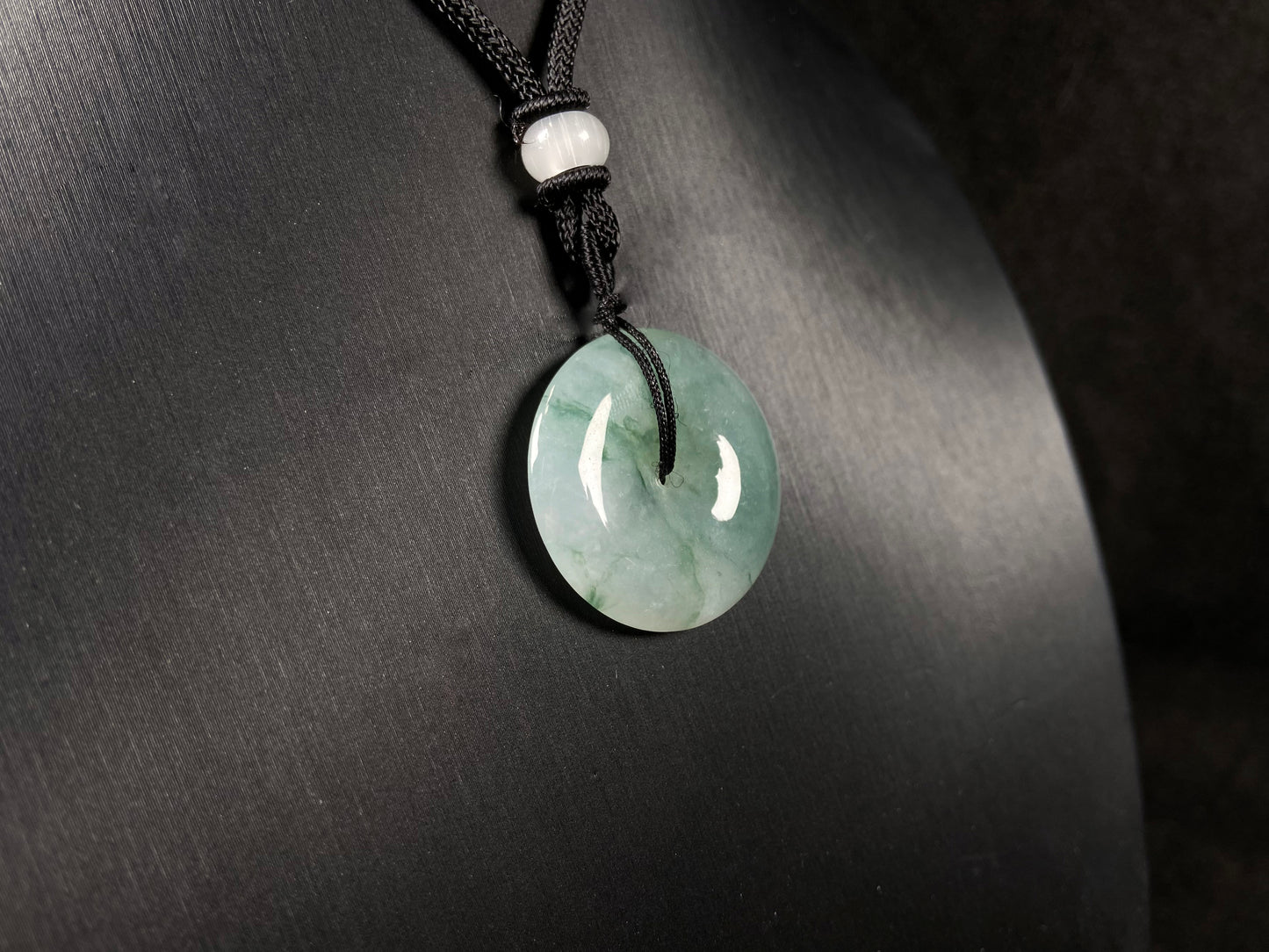 This is a loose jadeite disc in the classic “Ping An Kou” form, featuring a pale green tone throughout.