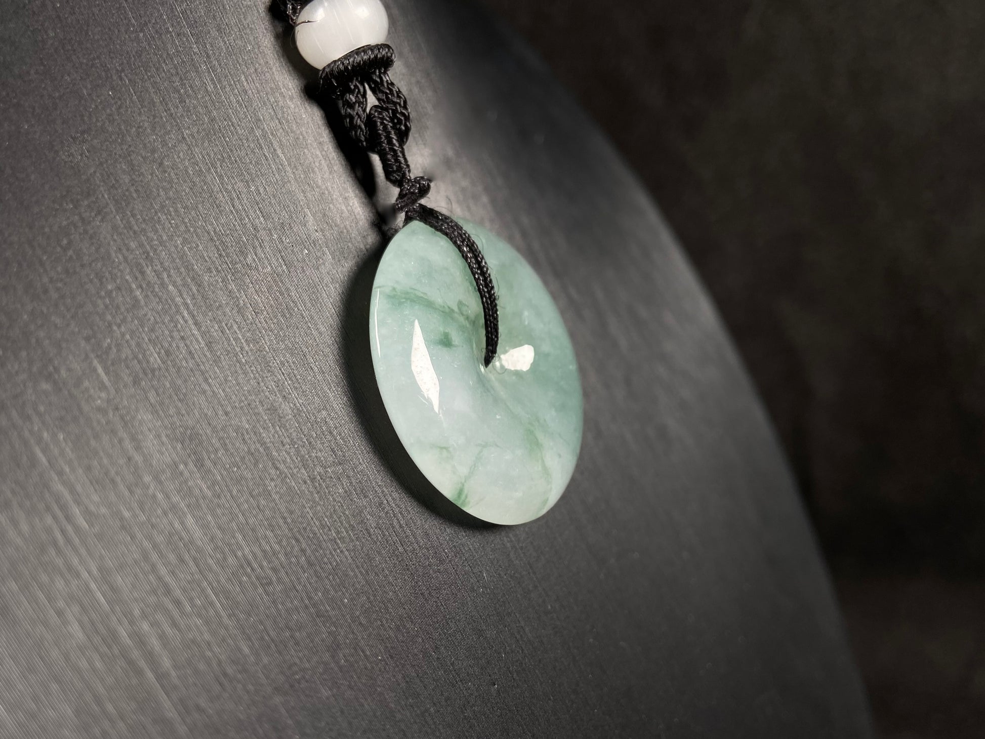 This is a loose jadeite disc in the classic “Ping An Kou” form, featuring a pale green tone throughout.