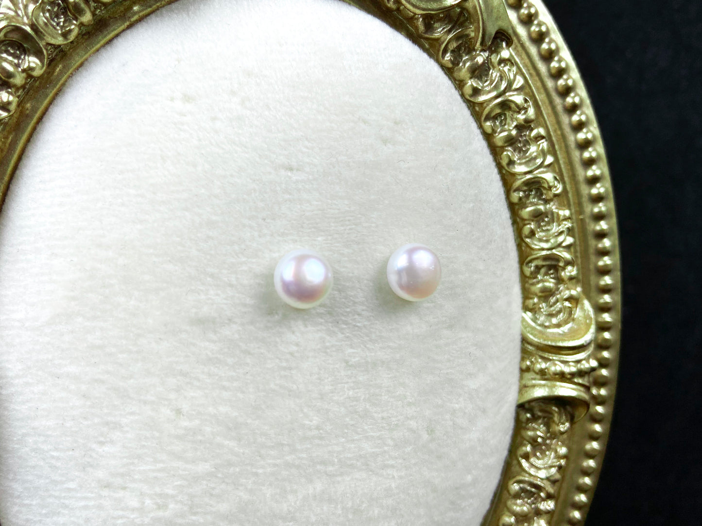 A pair of bloom pink glow pearl earrings.