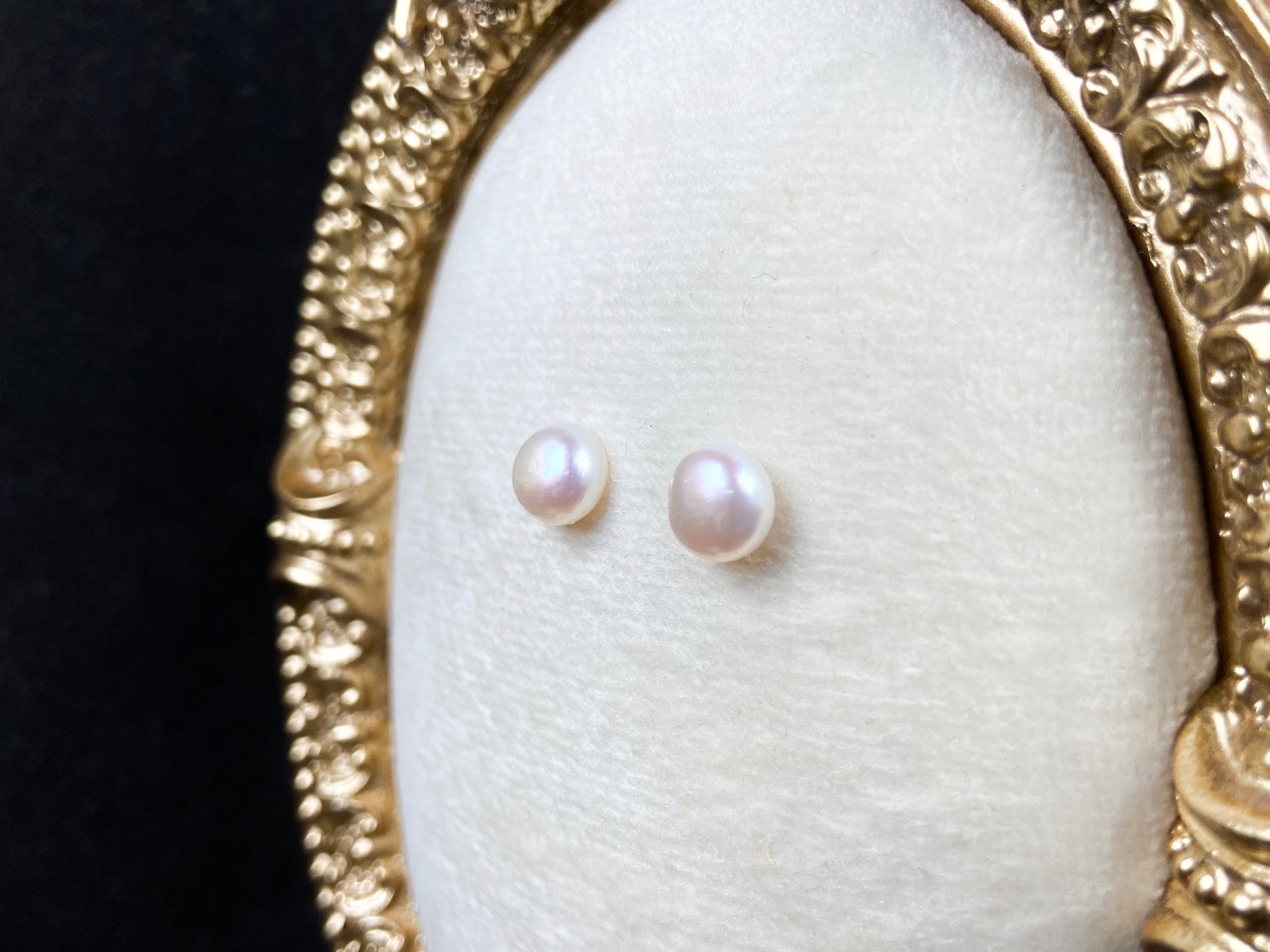 A pair of bloom pink glow pearl earrings.