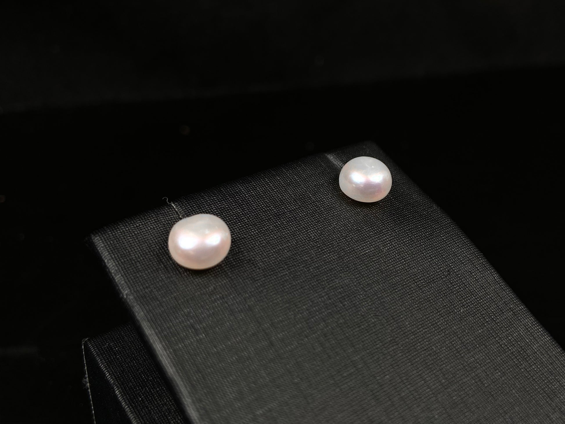 A pair of bloom pink glow pearl earrings.