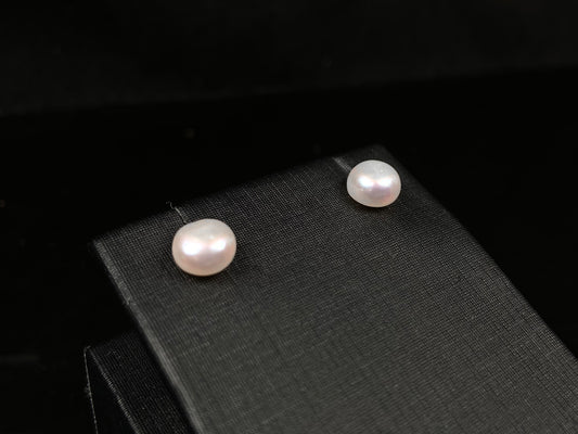 A pair of bloom pink glow pearl earrings.