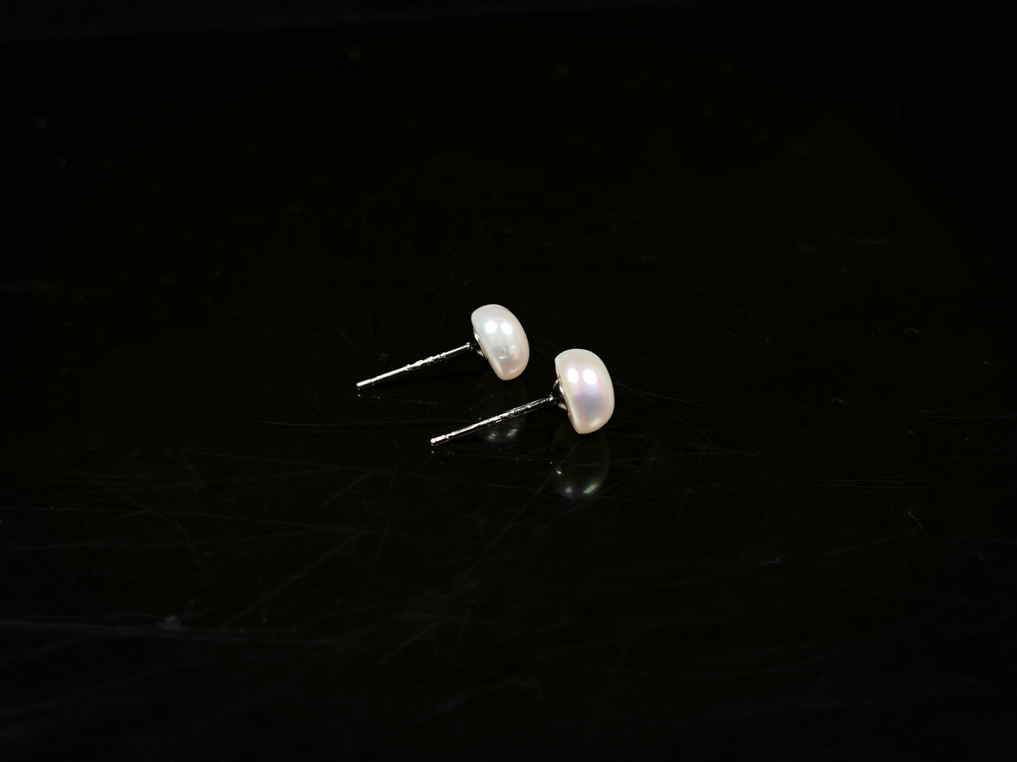 A pair of bloom pink glow pearl earrings.