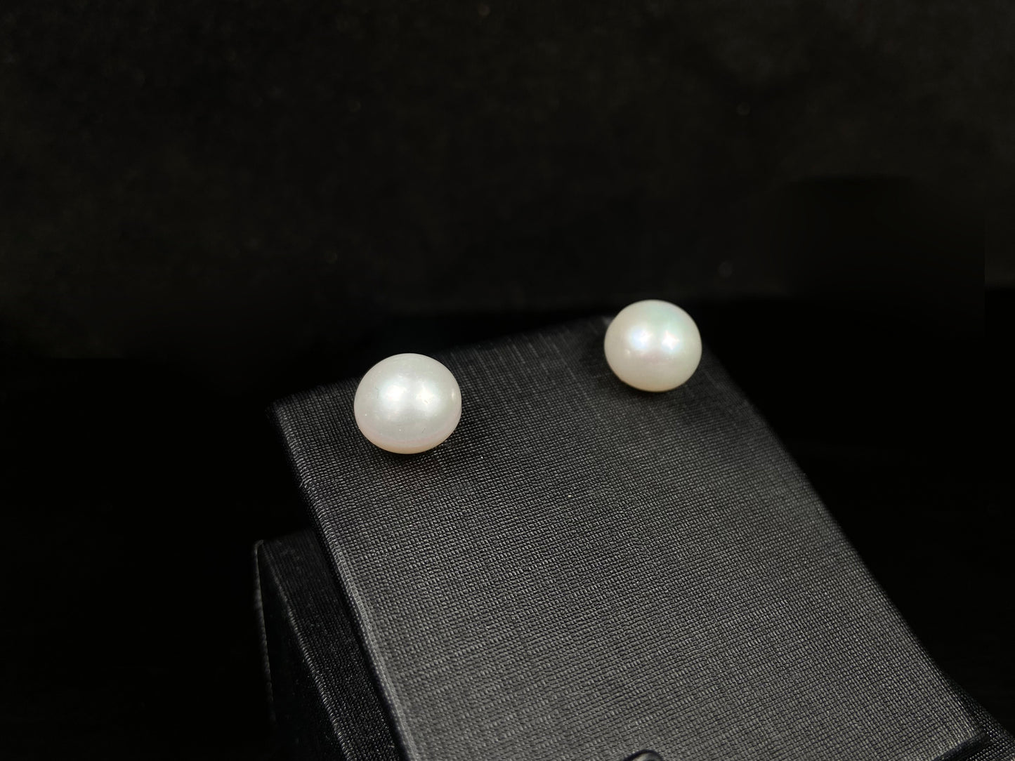 A pair of soft milky white shine pearl earrings.