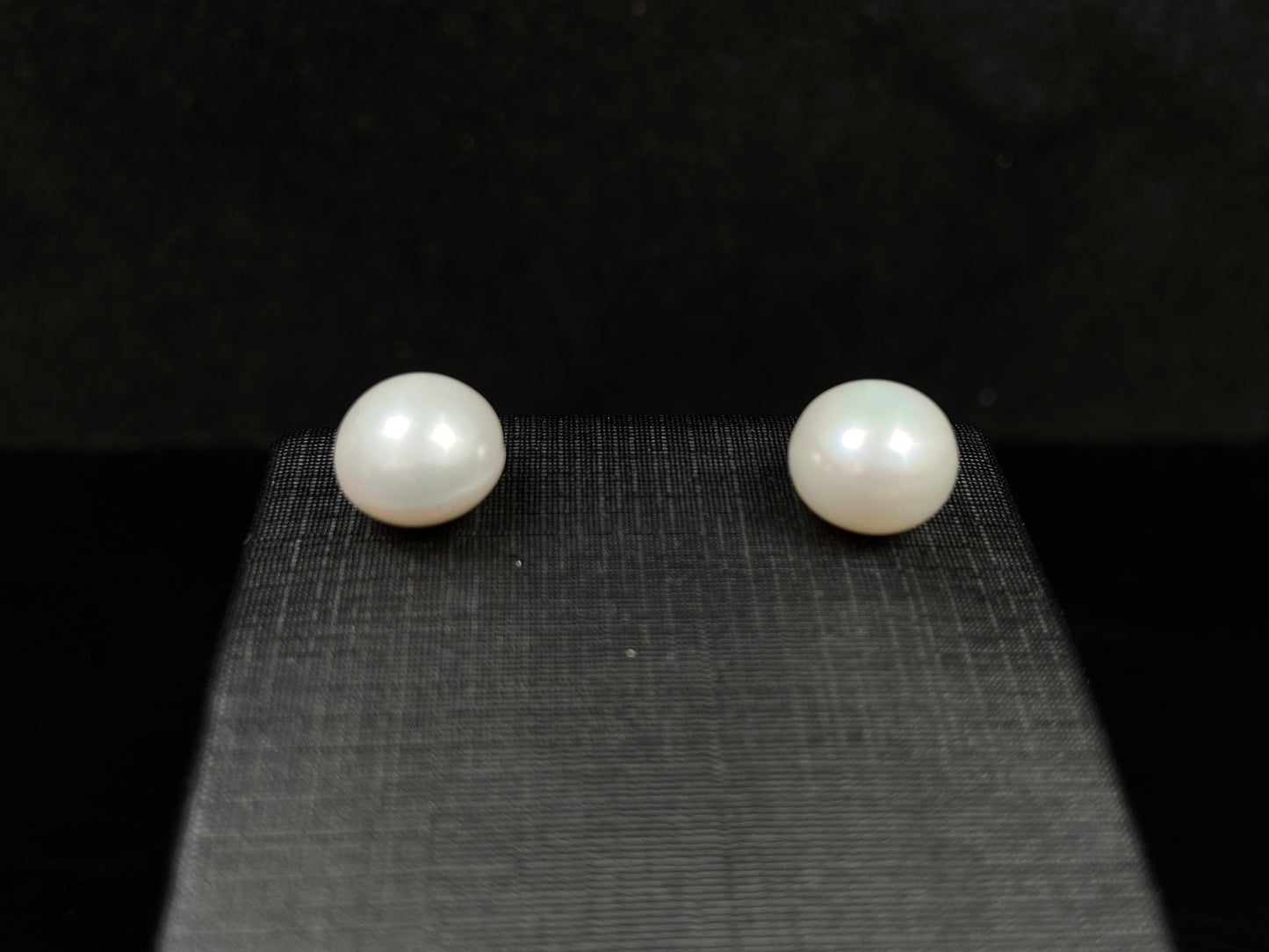 A pair of soft milky white shine pearl earrings.
