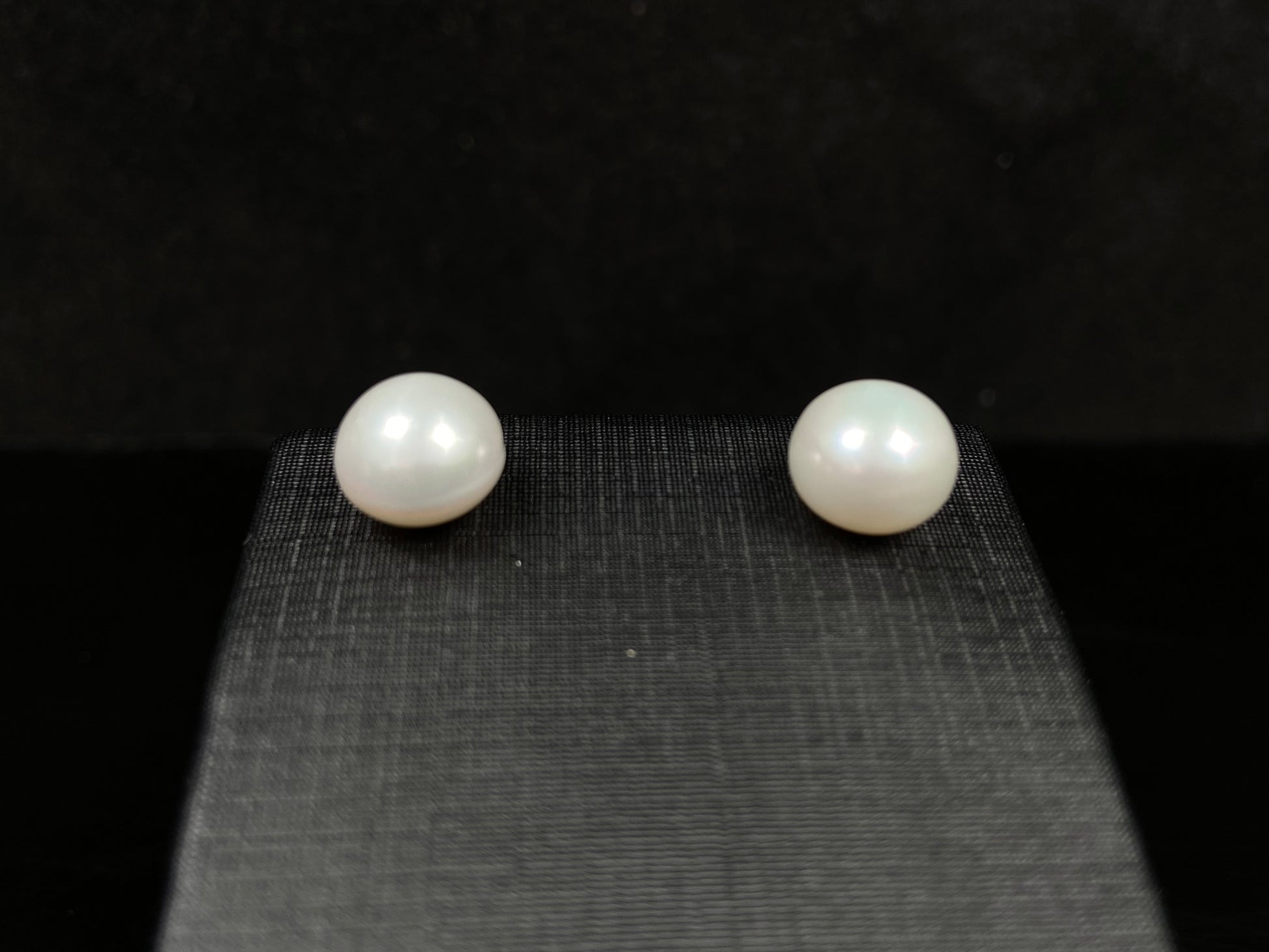 A pair of soft milky white shine pearl earrings.