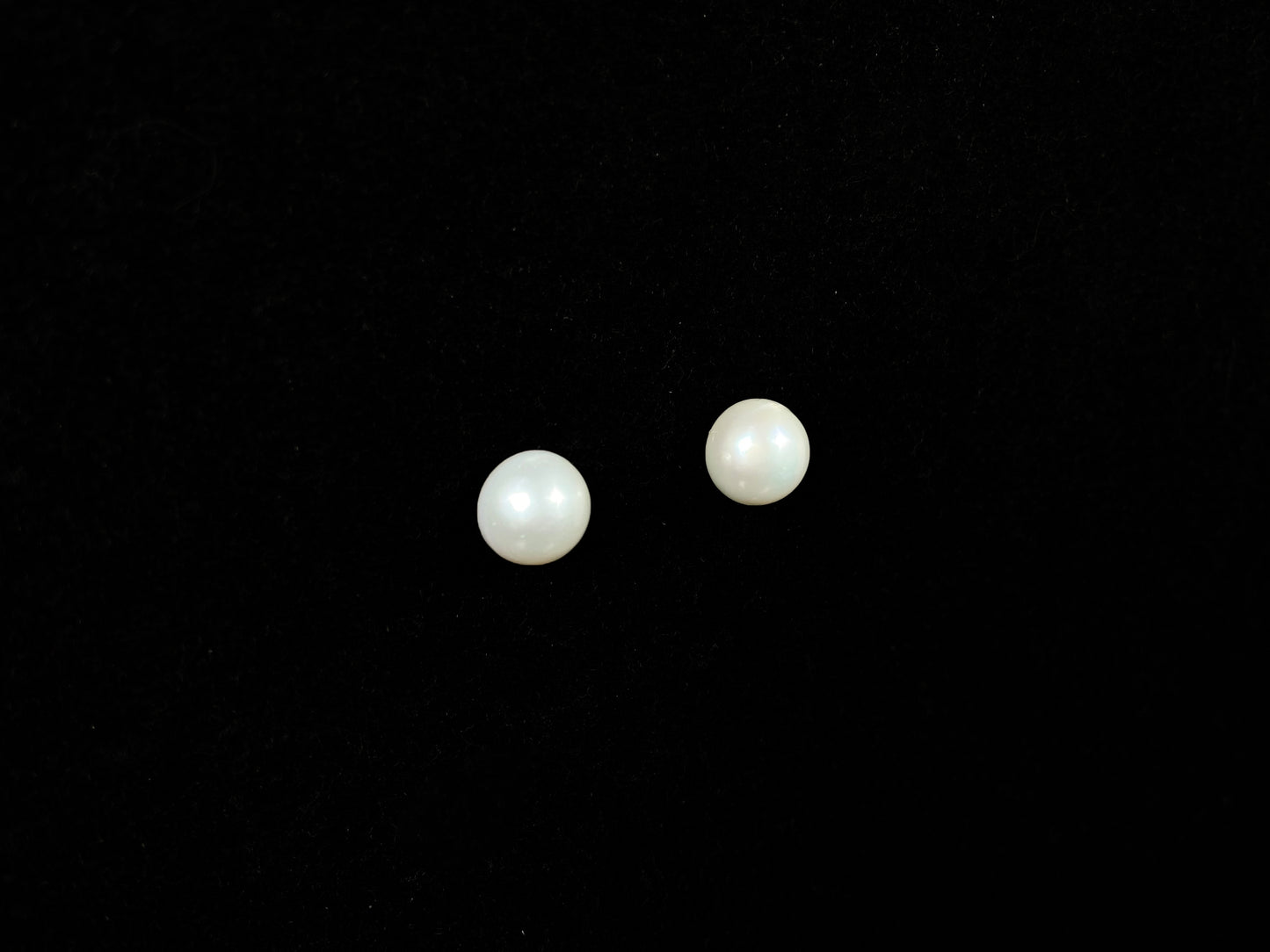 A pair of soft milky white shine pearl earrings.