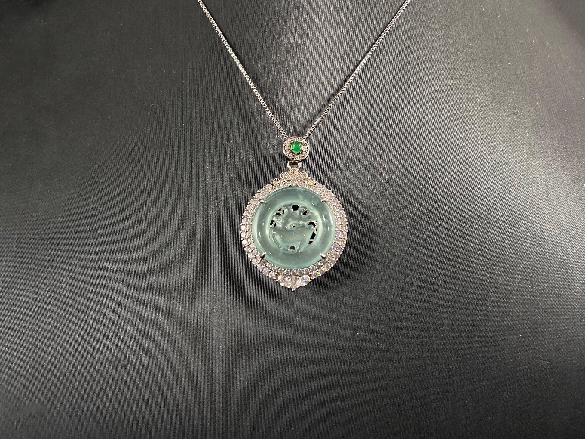 A circular pendant features a light green jade deer enclosed within a jade ring, all framed in 925 silver.