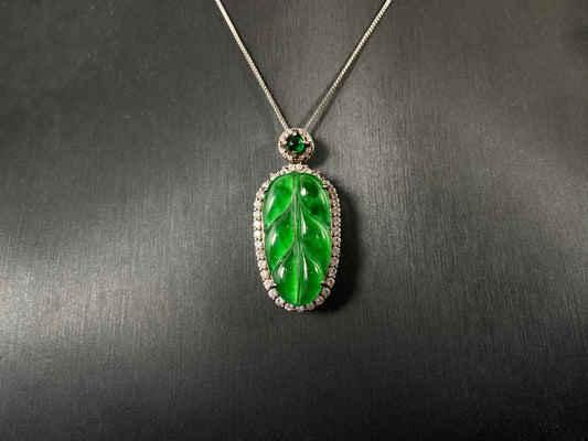 A leaf shaped emerald jadeite pendant, elegantly framed by a 925 sterling silver border.