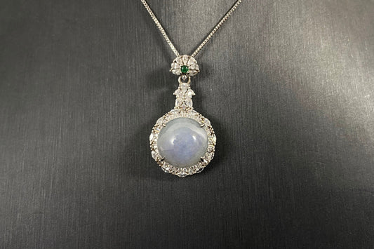 A semi transparent, pale lavender jade bead is elegantly encircled by a 925 silver frame.