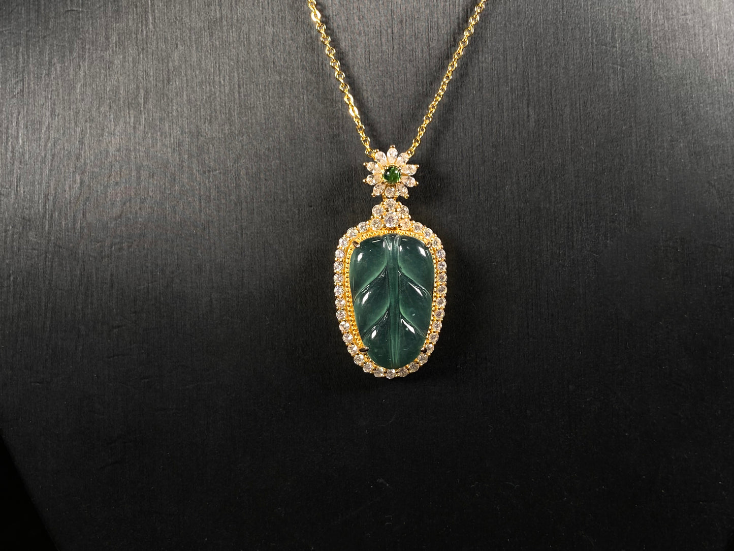 A deep aqua leaf vein jadeite pendant.