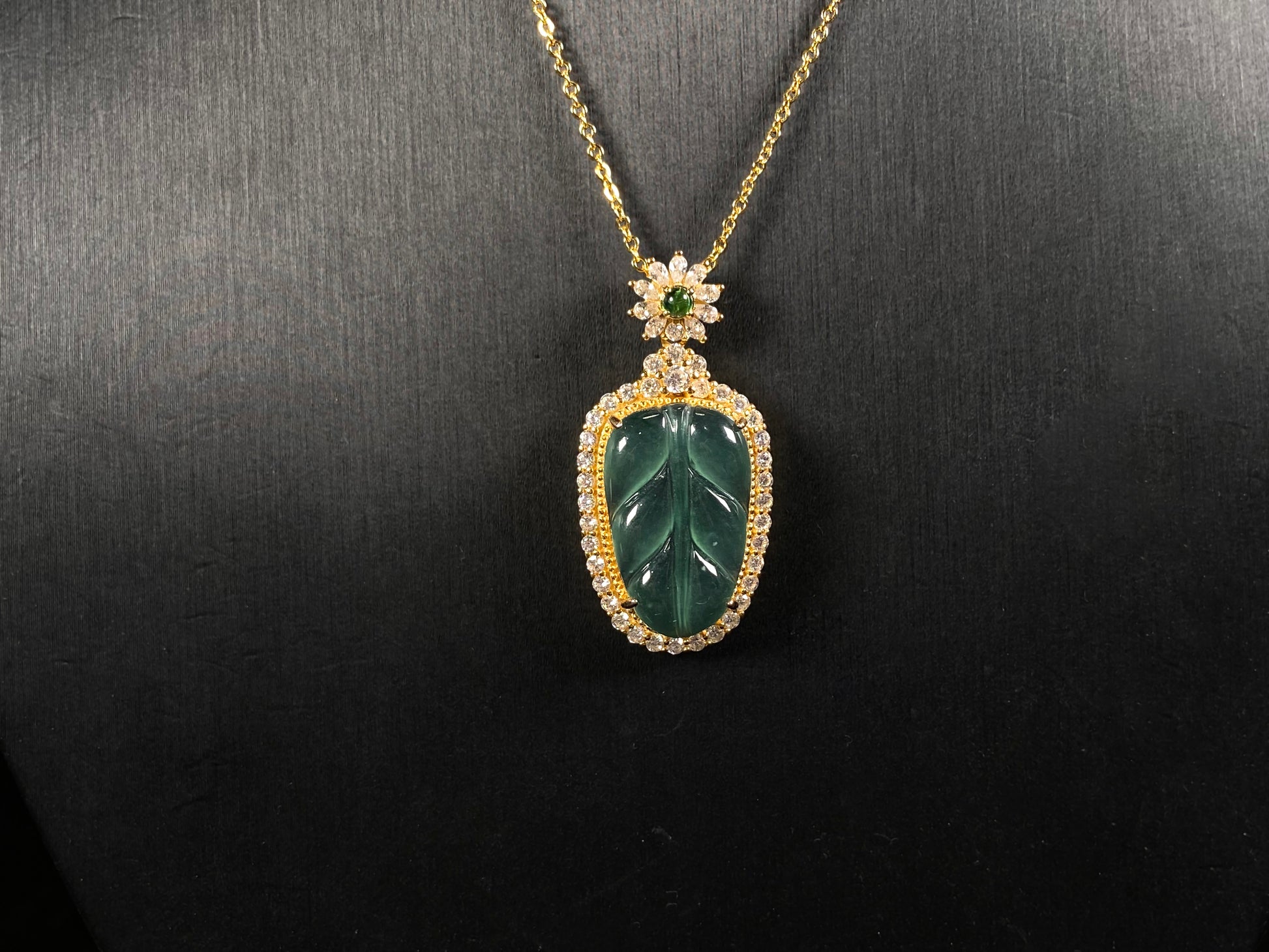 A deep aqua leaf vein jadeite pendant.