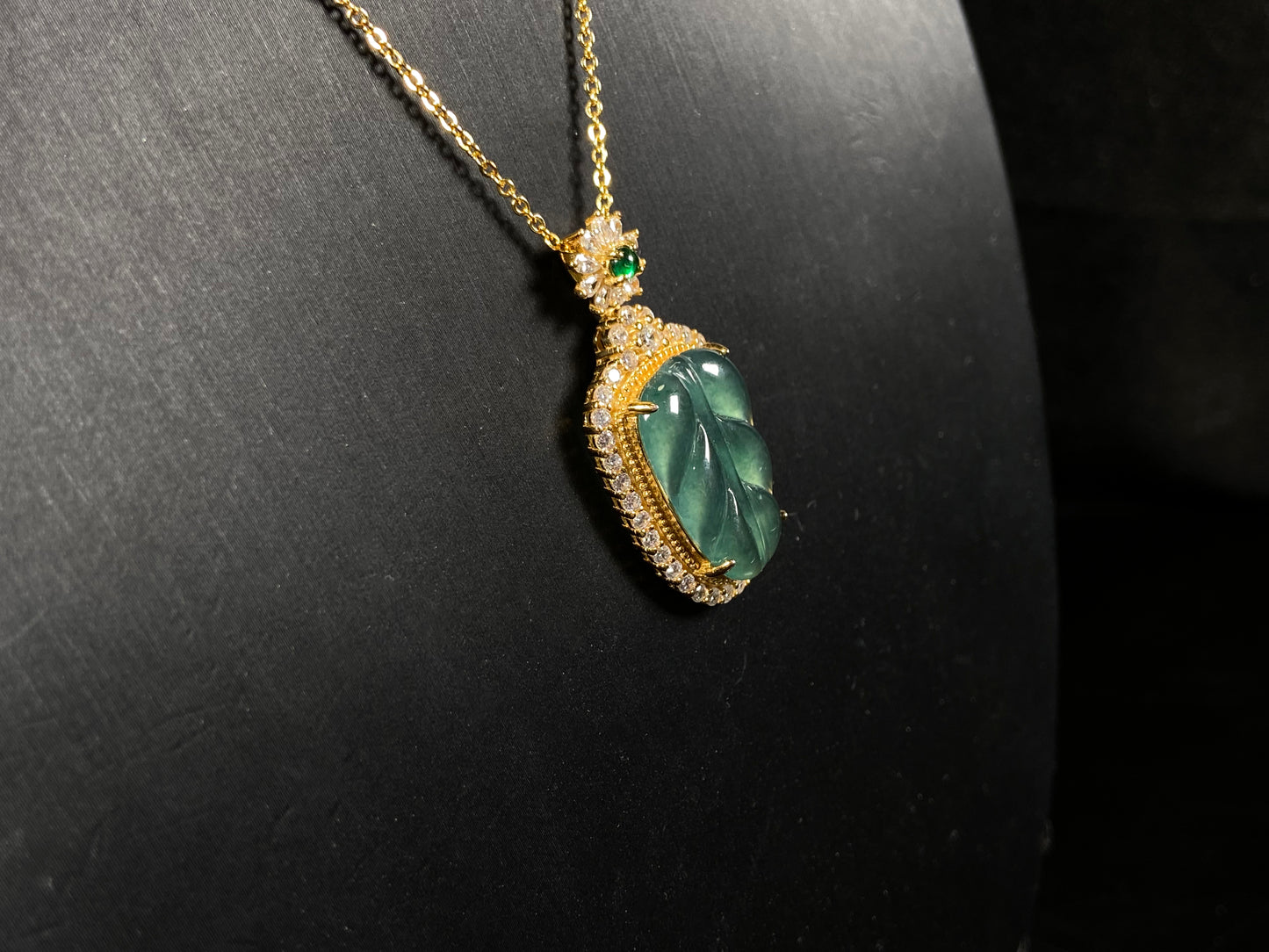 A deep aqua leaf vein jadeite pendant.