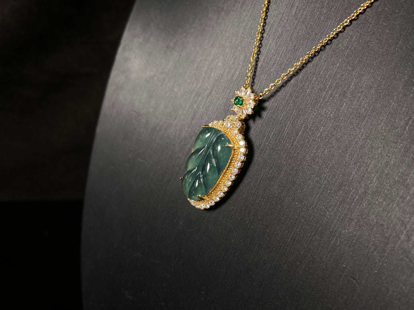 A deep aqua leaf vein jadeite pendant.