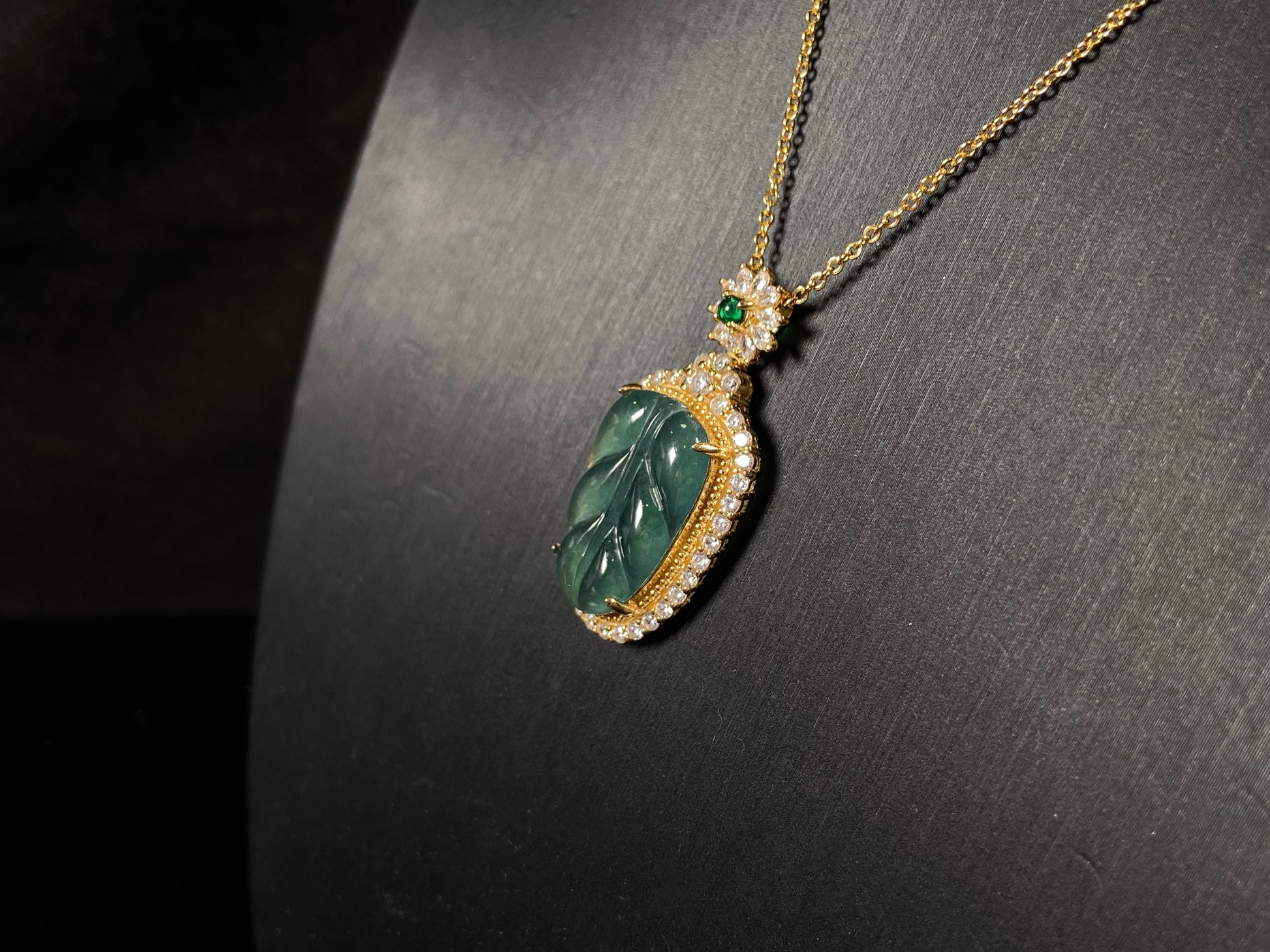 A deep aqua leaf vein jadeite pendant.