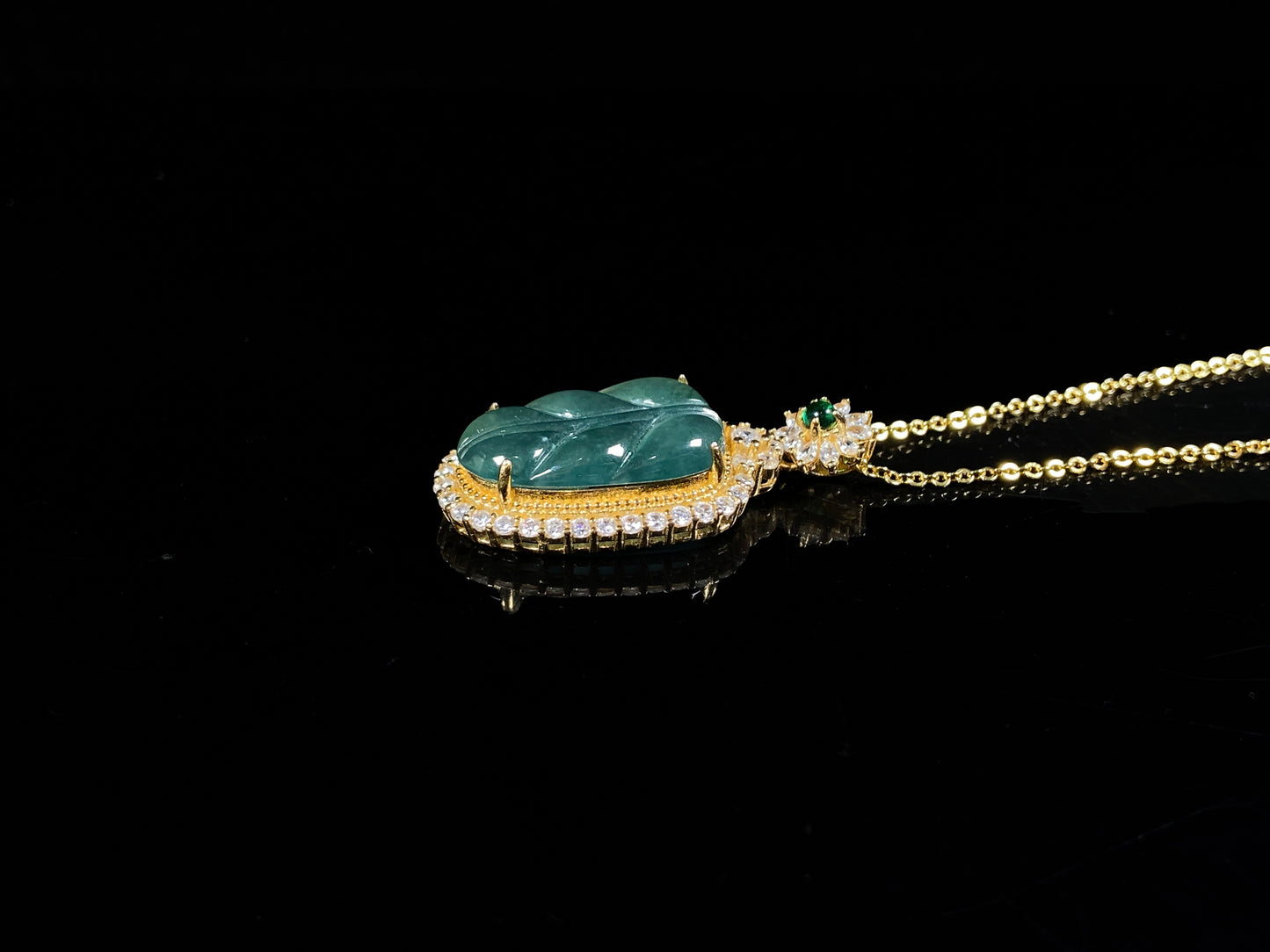 A deep aqua leaf vein jadeite pendant.