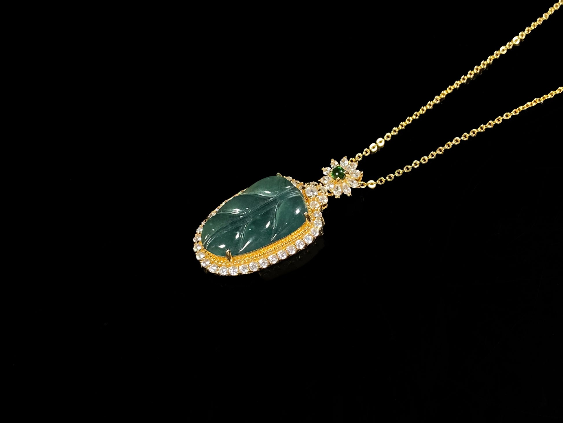 A deep aqua leaf vein jadeite pendant.