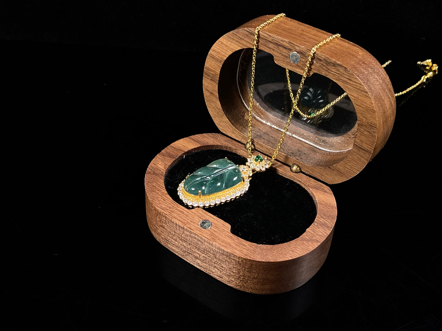 A deep aqua leaf vein jadeite pendant.