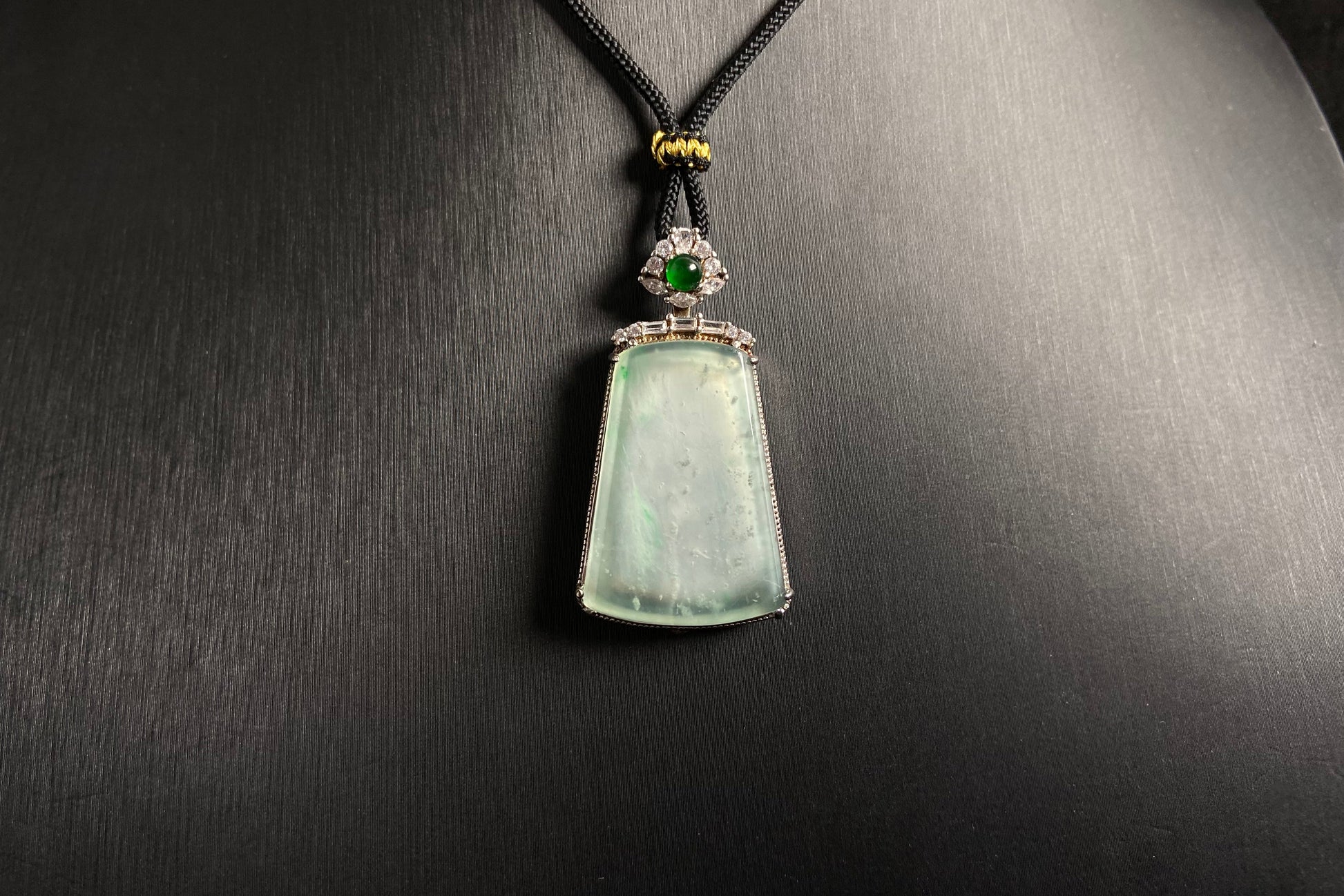 A clear light green "Wu Shi" plaque pendant, framed in 925 silver.